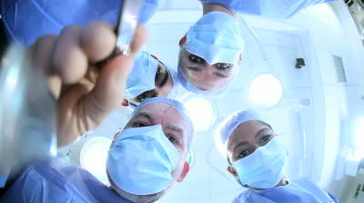 stock-footage-faces-hands-male-female-surgeons-nurses-wearing-surgical-scrubs-in-operating-room